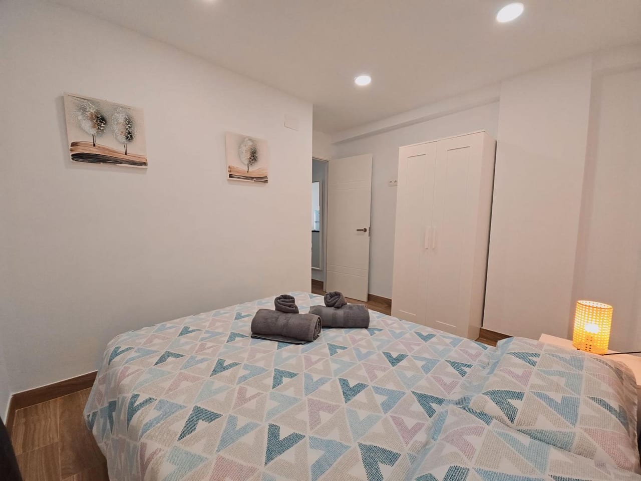 a bedroom with a bed with a quilt on it at La casita de Mercedes in Málaga
